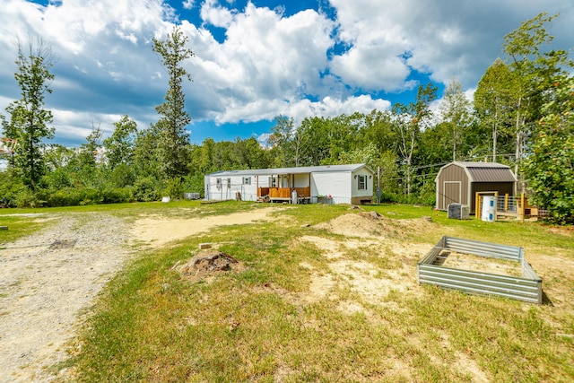 view of yard with a shed and a deck