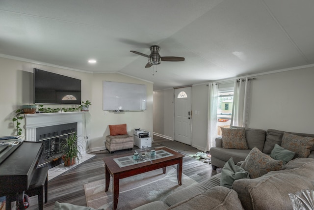 living room featuring lofted ceiling, hardwood / wood-style floors, ceiling fan, and ornamental molding