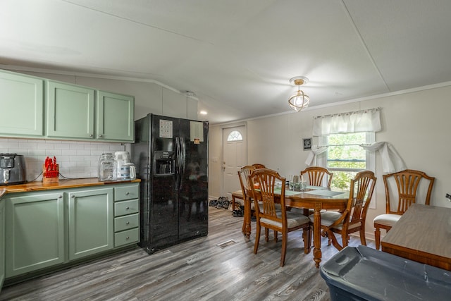 dining area with crown molding, vaulted ceiling, and dark hardwood / wood-style flooring