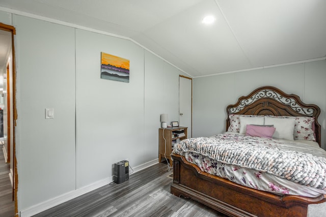 bedroom with vaulted ceiling and dark hardwood / wood-style floors