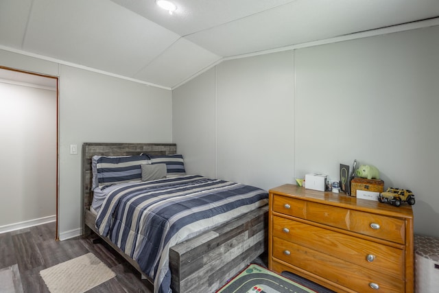 bedroom with vaulted ceiling and dark hardwood / wood-style flooring