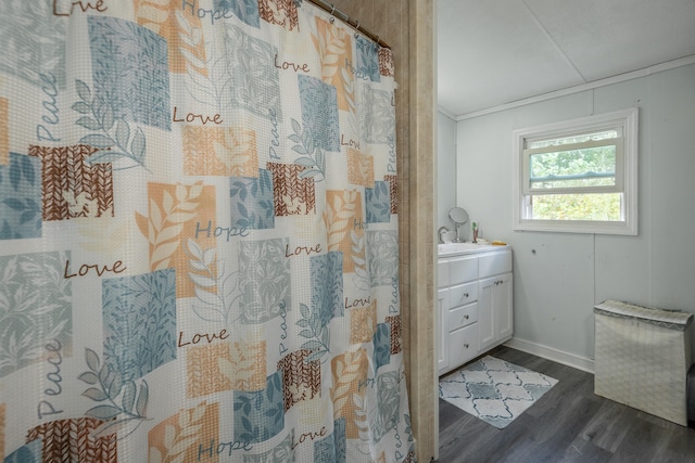 bathroom featuring a shower with shower curtain, wood-type flooring, ornamental molding, and vanity