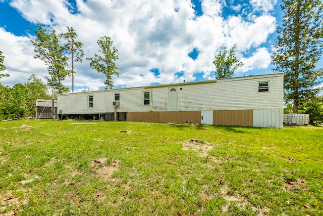 rear view of property with a lawn