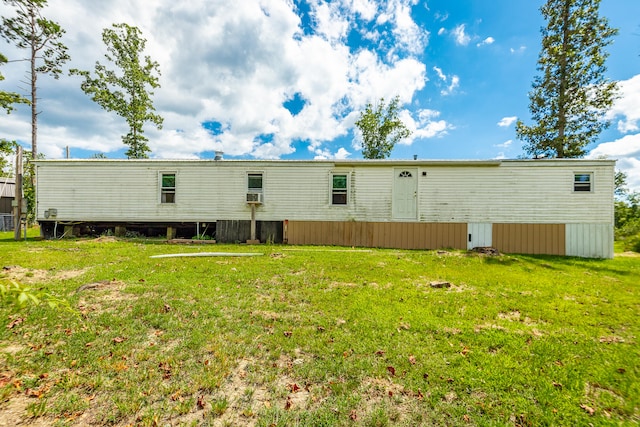 rear view of property featuring a yard