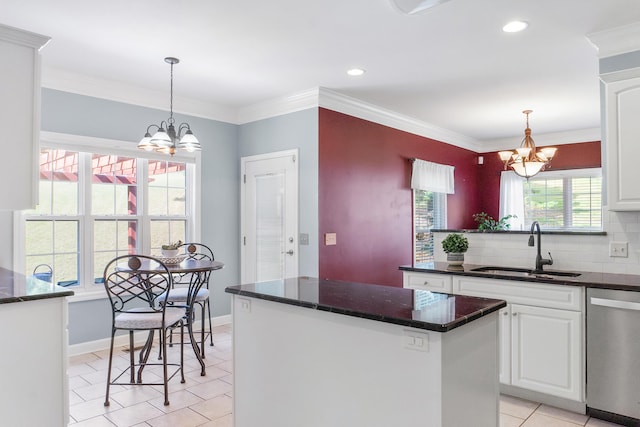 kitchen with stainless steel dishwasher, a center island, sink, and a notable chandelier