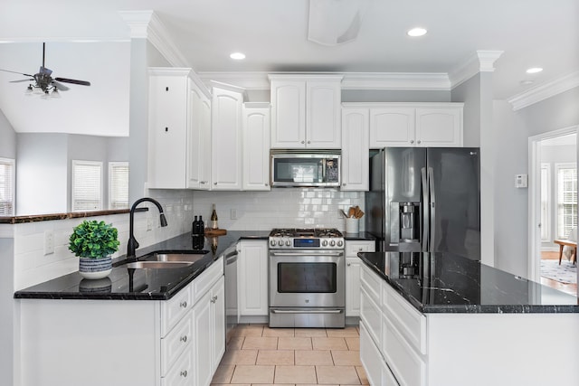 kitchen with ceiling fan, sink, tasteful backsplash, appliances with stainless steel finishes, and dark stone countertops