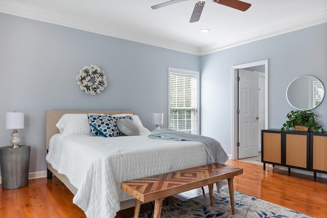 bedroom featuring ornamental molding, ceiling fan, and hardwood / wood-style flooring