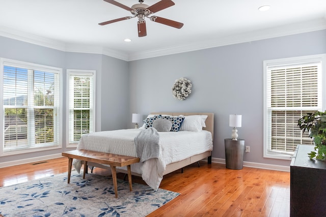 bedroom with light hardwood / wood-style flooring, multiple windows, and ceiling fan