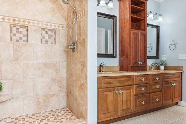 bathroom with tile patterned floors, vanity, and tiled shower