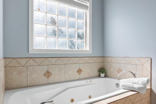 bathroom featuring a relaxing tiled tub