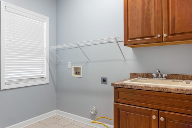 washroom with washer hookup, cabinets, sink, electric dryer hookup, and light tile patterned floors