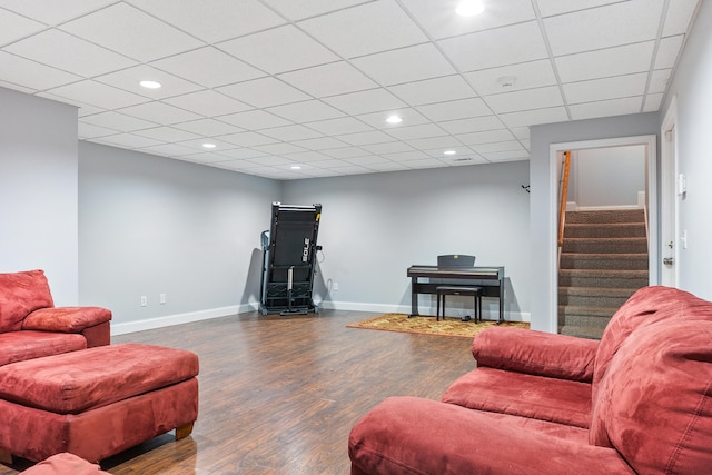 living room featuring wood-type flooring and a paneled ceiling