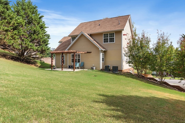 back of property with a lawn, cooling unit, and a patio area