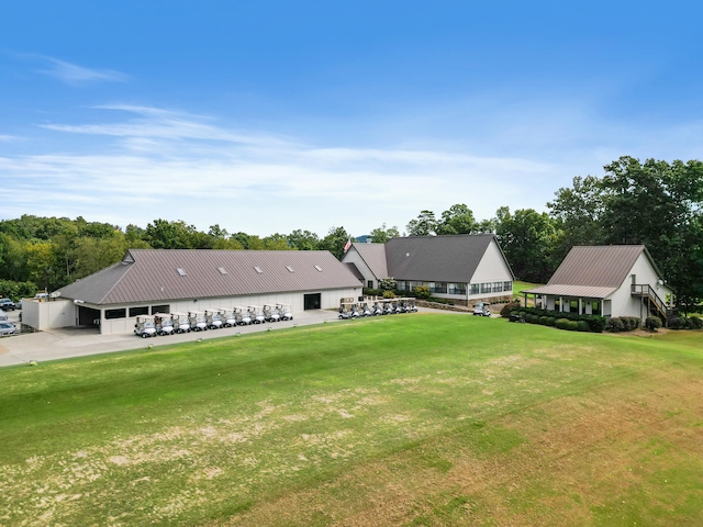 rear view of property with a yard and a carport