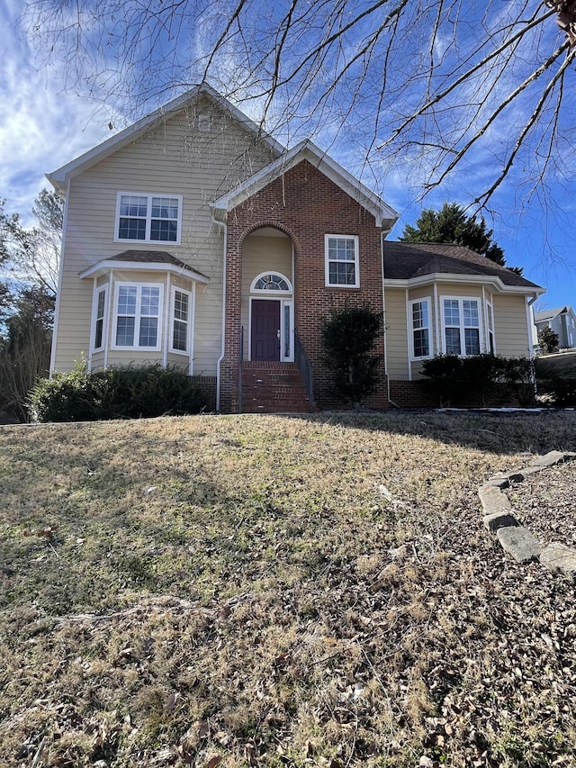 view of property featuring a front lawn