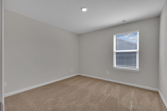 unfurnished room featuring light colored carpet