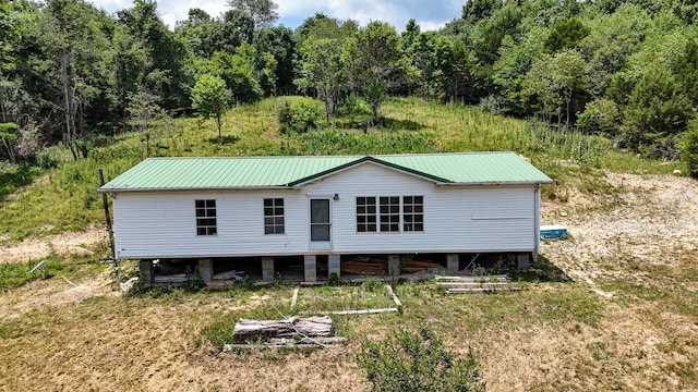 back of property with metal roof