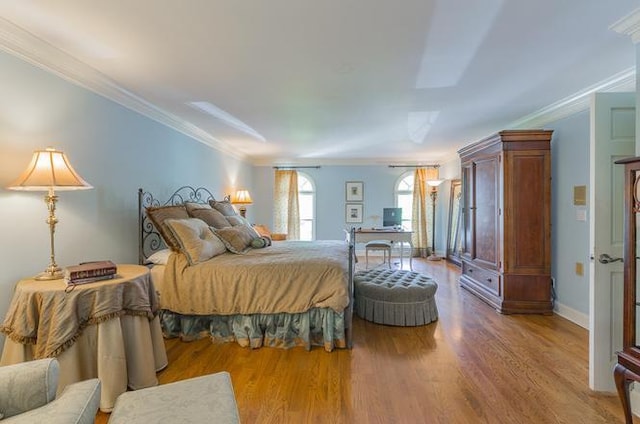 bedroom featuring crown molding and hardwood / wood-style flooring