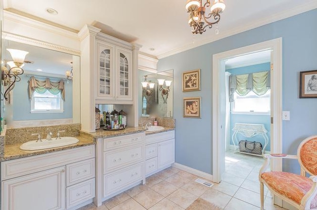 bathroom with vanity, a wealth of natural light, an inviting chandelier, and tile patterned flooring