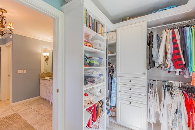 spacious closet with light tile patterned floors and a chandelier