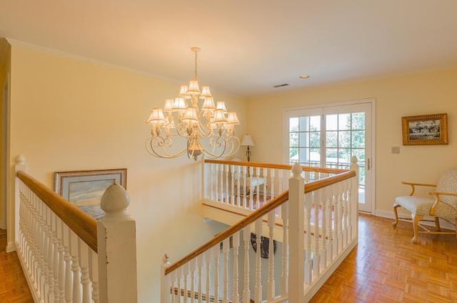 hallway with a notable chandelier and light parquet flooring