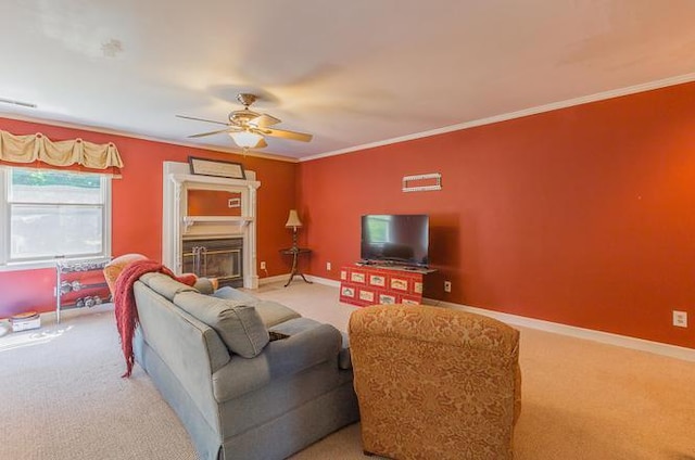 living room with ceiling fan, ornamental molding, and carpet floors