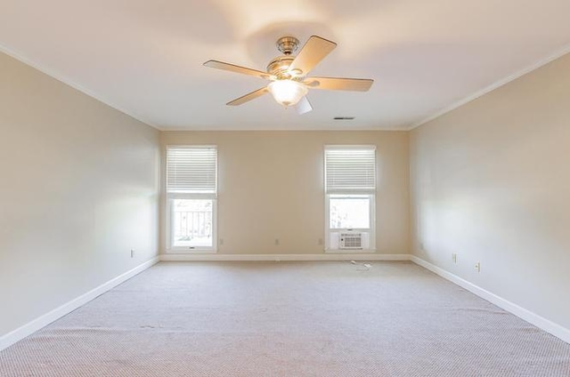 spare room featuring light carpet, crown molding, cooling unit, and ceiling fan