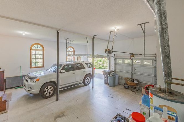 garage with a garage door opener and electric water heater