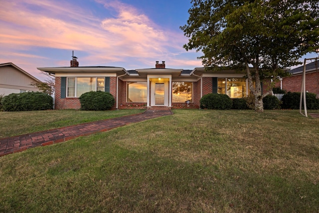 ranch-style house featuring a lawn