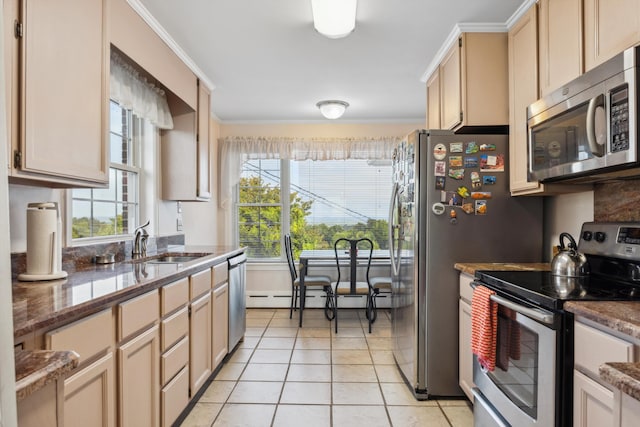 kitchen with crown molding, a healthy amount of sunlight, stainless steel appliances, and light tile patterned floors