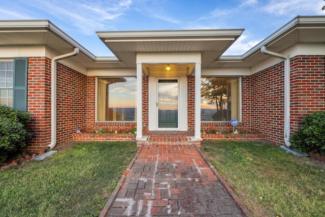 property entrance with a lawn and a porch