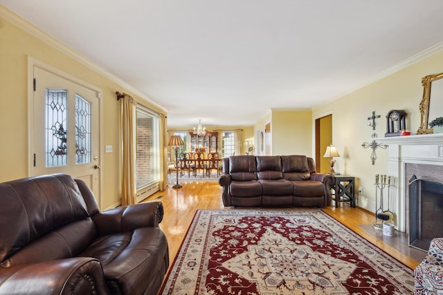 living room featuring crown molding, hardwood / wood-style flooring, and a chandelier