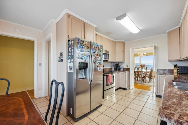 kitchen with crown molding, light brown cabinets, appliances with stainless steel finishes, and a chandelier