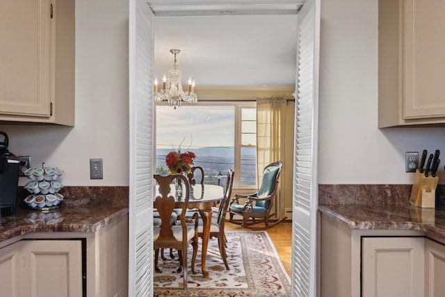 kitchen featuring crown molding, a notable chandelier, and light hardwood / wood-style floors