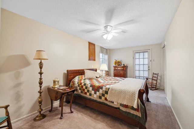 carpeted bedroom featuring a textured ceiling, ceiling fan, and a closet