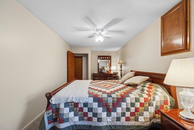 bedroom with a textured ceiling and ceiling fan