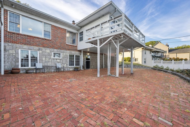 rear view of property with a patio area and a deck