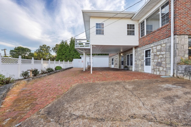 back of property with a carport