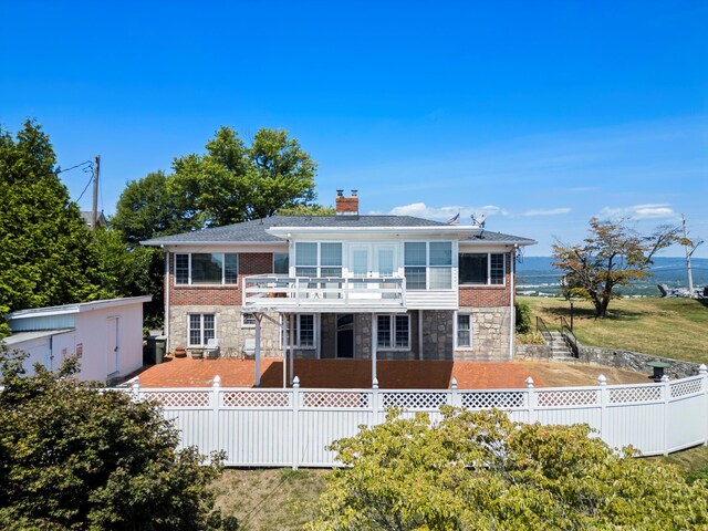 back of house with a balcony