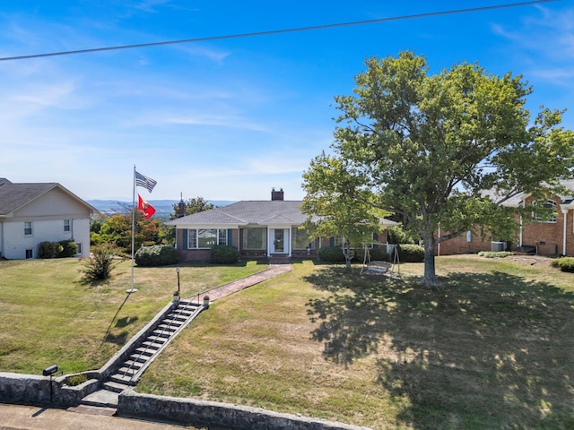 ranch-style house featuring a front yard