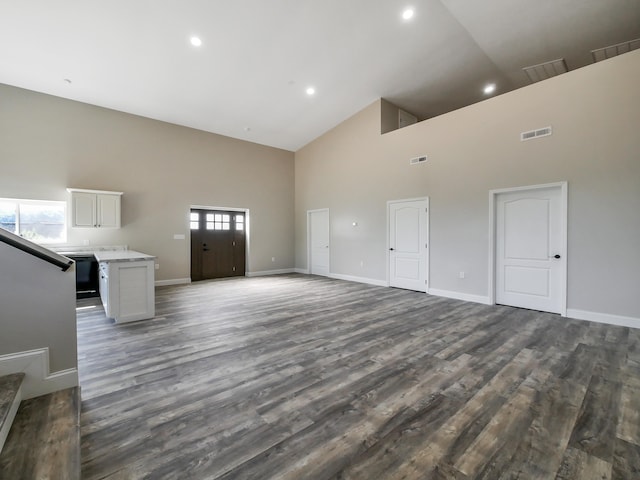 unfurnished living room featuring hardwood / wood-style floors and high vaulted ceiling