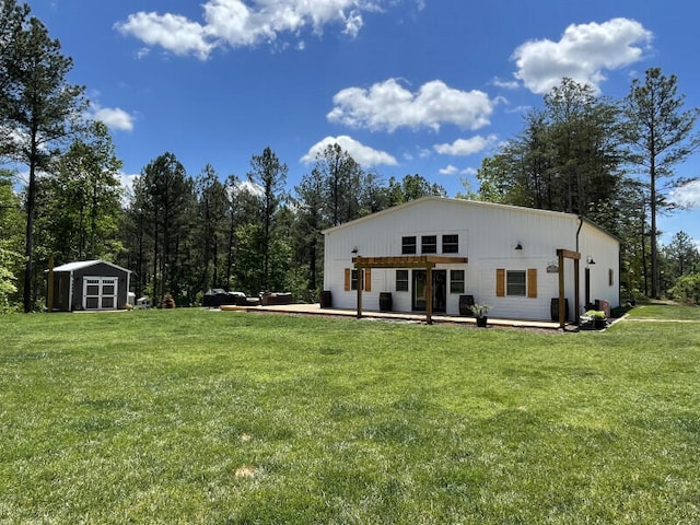 back of property with a yard, a patio, and a storage unit