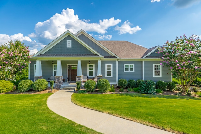 craftsman house with a porch and a front yard