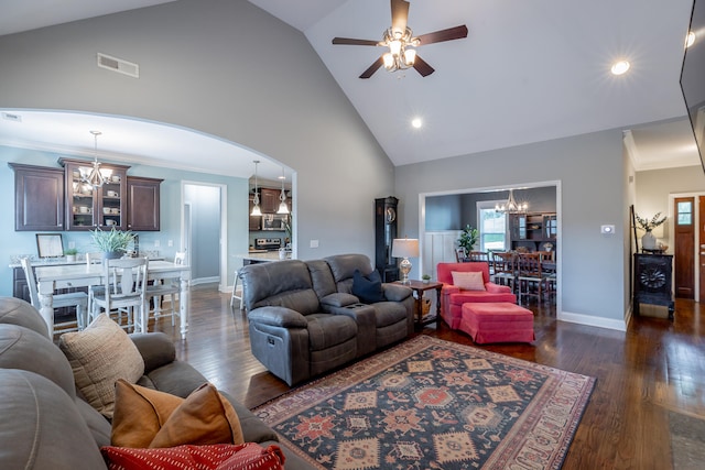 living room featuring dark wood-type flooring, ceiling fan with notable chandelier, high vaulted ceiling, and crown molding