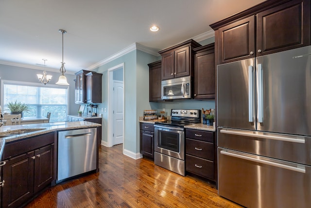 kitchen with stainless steel appliances, light stone countertops, hanging light fixtures, dark wood-type flooring, and dark brown cabinetry