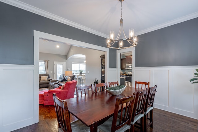 dining room featuring crown molding, dark hardwood / wood-style flooring, a chandelier, and lofted ceiling