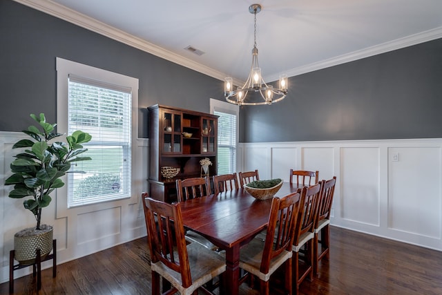 dining space featuring crown molding, dark hardwood / wood-style floors, and a chandelier