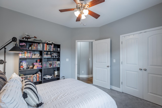 carpeted bedroom with ceiling fan and a closet