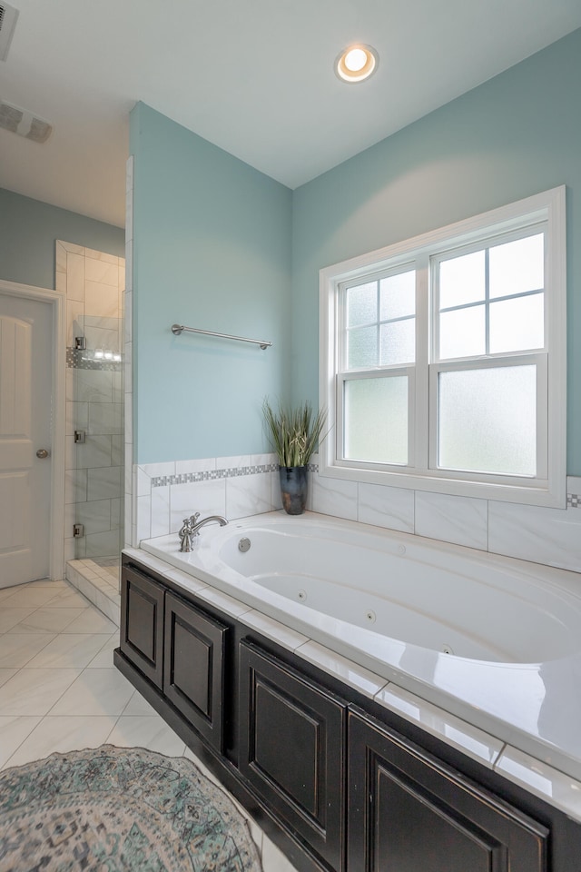 bathroom with separate shower and tub and tile patterned floors