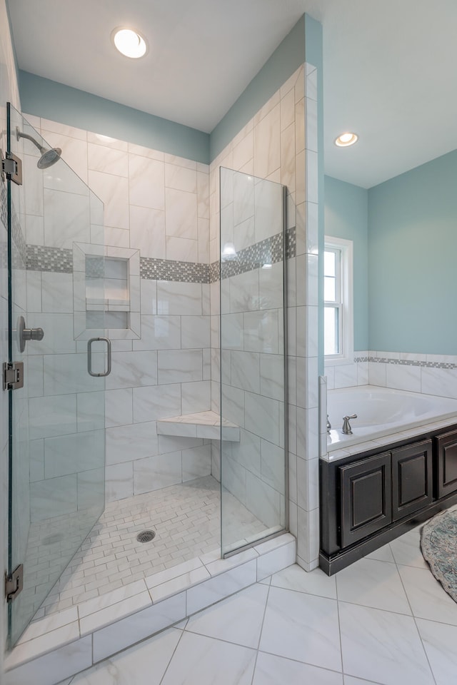 bathroom with separate shower and tub